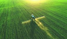 aerial-drone-tractor-spraying-corn-field